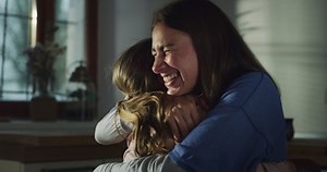 clip-1079883893-authentic-shot-mother-daughter-hugging-kitchen-home