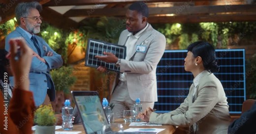 lack business professional demonstrates solar panel model to colleagues during strategic meeting, explaining sustainable energy solution and discussing project details in modern eco office.