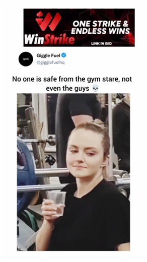 Giggle Fuel on Instagram: "The video is set in a gym where a man is performing heavy deadlifts. While he is focused on his workout, the camera pans to show a young woman sitting on a nearby bench, casually sipping water from a plastic cup. She isn't working out; instead, she is staring intensely at the man while he lifts. She follows his movements closely with a very serious and unblinking expression, making for a humorous and slightly awkward moment. Her fixed gaze remains on him throughout his