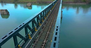 Download Train tracks cross a steel bridge for free