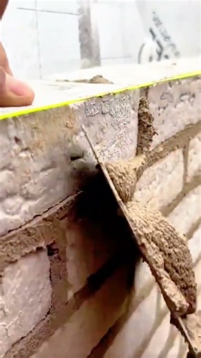 Carefully stacking each brick to form a strong and perfectly aligned wall #Brickwork #Construction