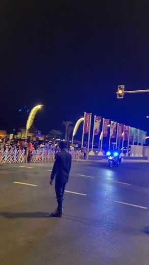 Nighttime Security Scene with Guard and City Traffic