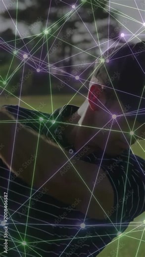 Vertical video: Male golfer addressing ball, executing swing, animated overlay mapping swing plane