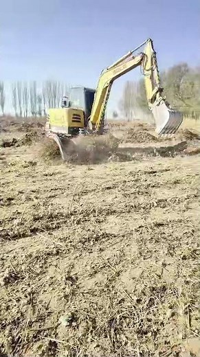 Excavator Turns Over the Mud in the Field, Dirt Flying!