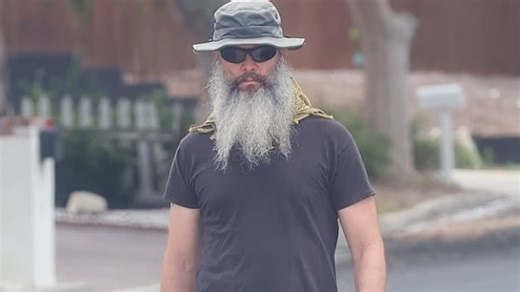 Christopher Daniel Barnes, 52, sports a bushy beard on a stroll