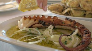 Eating fried octopus in restaurant