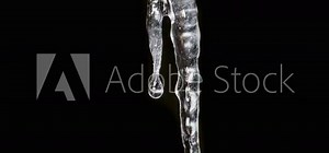 Time lapse sequence of a growing icicle in front of a black background
