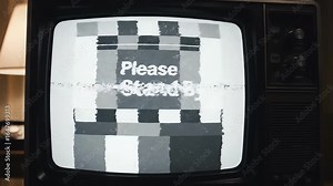 Old television set with a classic 'Please Stand By' message on a black and white test pattern screen, symbolizing a broadcast interruption or technical difficulties.
