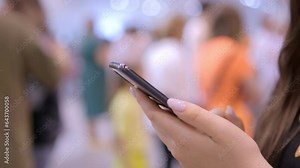 Close up woman wear protective mask using smartphone standing inside the mall supermarket, paying bills through phone 4g 5g technology,