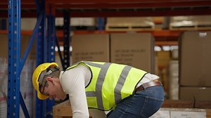 Male warehouse engineer manager suffering from back injury during checking stock working at warehouse factory, Storage worker having back pain at work