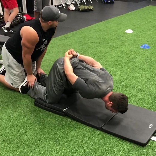 Razor Curl — This exercise is a great way to train the loading of hamstrings as the athlete moves from hip extension back into flexion. This exercise, along with teaching and performing efficient mechanics on plyometric, agility, and speed drills, can reduce the risk of hamstring and ACL injury as well. #strengthandconditioning #strengthtraining #plyometrics #agility #sprinting #performance | Premier Athlete Training