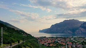 Panorama of Torbole a small town on Lake Garda, Italy. Europa, beautiful Lake Garda surrounded by mountains in the summer time at sunset Stock Video