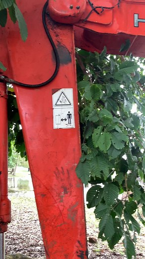 Red Excavator in Action: Muddy Operation Explained