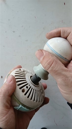 Discovering the inner workings of a broken mini ceiling fan found in a pile of old items.