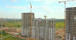 Drone view of Modern residental complex under construction. Concrete constructioning. Tower cranes at work.