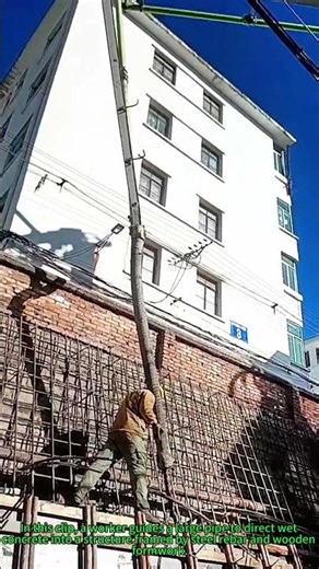 Concrete Pouring: Worker Guides Pipe for Even Concrete Placement