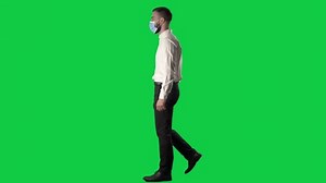 clip-1070520301-side-view-walking-business-man-face-mask