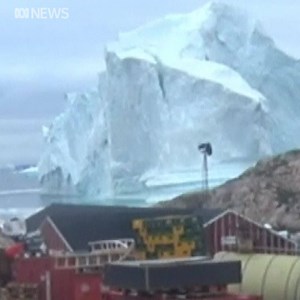 Iceberg drifts towards Greenland village