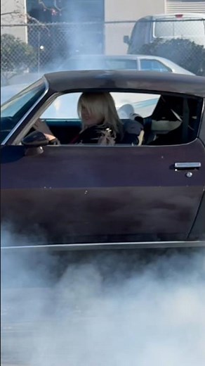 Woman doing her first burnout in a 1970 Camaro