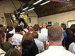 Disgruntled commuters queue for an escalator at Waterloo station