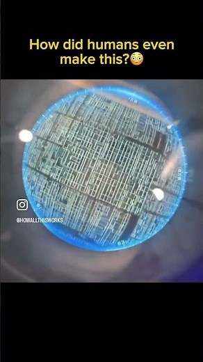 An iPhone CPU under a microscope, with a hair strand for size reference.