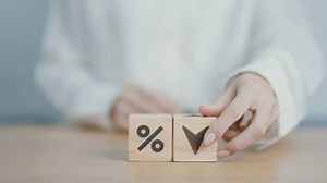 wood block of percentage change to UP and Down arrow. Interest rate, GDP, stocks market, financial, deflation and Inflation, ranking, mortgage, debt, Loan and Economic Recession concept