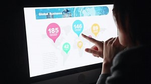 Woman looking at a computer screen in a dark room