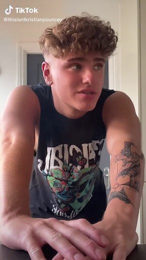 Curly-Haired Individual with Shark Tattoo in Unique Style