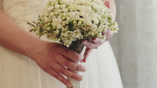 Bride holding her bouquet of white flowers - Free Stock Video