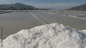 Salt lake, white salt crystals, salting. sea salt evaporation pond. manufacture of salt. largest mineral mining in Asia.