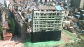 Downtown building demolition by controlled implosion in China