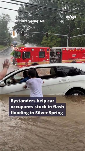 1.7M views · 16K reactions | WTOP's Dave Dildine captured this video of bystanders helping occupants of a car out of flash flooding in Silver Spring, Maryland, on Saturday. The car began slowly spinning around the flooded intersection. One of the women was pulled from the vehicle by a bystander while the other was assisted onto higher ground by fire crews. Learn more about the rescue on WTOP.com or our app. Link in bio. (: WTOP/Dave Dildine) | WTOP News | Facebook