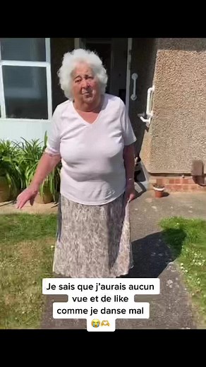 Elderly Woman Dancing Joyfully Outside Her Home