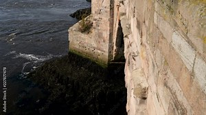 Close up-The River Tweed flows around the pilings of the Old Berwick bridge at Berwick-Upon-Tweed in Northumberland, England