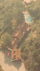 Shot from a helicopter in August 1969, this aerial view captures the secluded hilltop property at 10050 Cielo Drive, tucked into 3 acres above Benedict Canyon in the Santa Monica Mountains, overlooking Beverly Hills and Bel Air. The French country–style home, designed in 1941 by Robert Byrd for French screen star Michèle Morgan, was completed in 1942 and built to resemble a European farmhouse, with a main residence, guest house, pool, and two-story garage framed by dense pine and flowering cherr