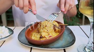 Stuffed squid with cheese, woman eating in restaurant. Mediterranean cuisine concept.