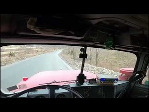 Mack R model tri-axle dump truck hauling stone