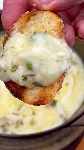 So easy and so delicious. Take a Brie Wheel and cut the rind off the top. Place the Brie in a pan and add some wine with some thyme. Grill some Italian bread because it goes perfect with this cheese. This all just takes a few mins to make. #recipes #grilling #cheese #hookedonbbq | Hooked on BBQ