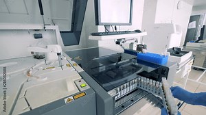 Bio samples are getting loaded into analyzing machine at a pharmaceutical plant.