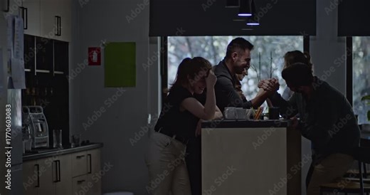 Students unwind in their college dorm, engaging in a friendly arm-wrestling match. Laughter and camaraderie fill the air as they enjoy a break from their studies.