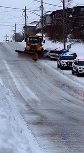 Out Of Control Snow Plow Crashes Into Parked Police Vehicles On Icy Hill Erie, Pennsylvania — A snow plow traveling downhill on a slick residential street lost control and collided with multiple parked police vehicles during an active investigation. The incident occurred amid heavy winter conditions with snow and ice covering the roadway. Video shows several marked police SUVs lined along the right side of the street with emergency lights flashing. As the plow descends the icy hill, its tires ap