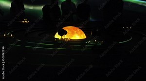 Planet models circling Sun observed by spectators in a darkness of Museum of the Future of Dubai
