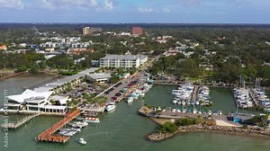 Drone footage over downtown Dunedin, Florida marina with boats and the Gulf of Mexico and Tampa Bay