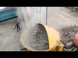 Tub grinder for shredding stump, tree roots.