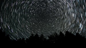 Stars move around a polar star. Time lapse of Star trails in the night sky. 4K