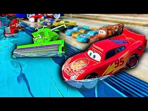 Disney Pixar Cars fall into the water: Lightning McQueen, Chick Hicks, Mack Trucks, Dinoco, Mater