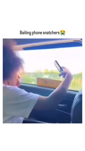 lifelol.vibe on Instagram: "The video captures passengers in a Lagos danfo bus dangling smartphones out the window during traffic to bait motorcycle-riding phone snatchers, a tactic born from frustration with rampant street crime in Nigeria's commercial hub. Posted by @NoContextHumans , known for curating absurd real-life moments, it amassed 1.9 million views overnight, underscoring how viral humor disarms serious issues like Lagos's estimated 5,000+ annual phone thefts reported by police. User 