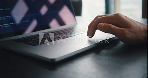 Close up male hand using touchpad on laptop computer while working at office. Closeup man programmer using laptop touchpad - pinch, swipe and scroll while working writing code in the IT industry