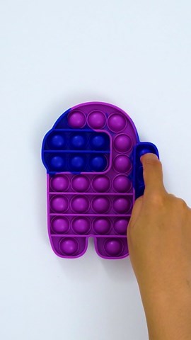 Popping purple Among Us fidget bubbles resulting in satisfying sensory play
