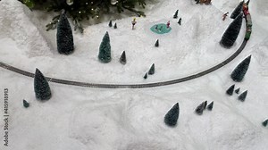 Train toys steam locomotive at landscape winter snow cover.